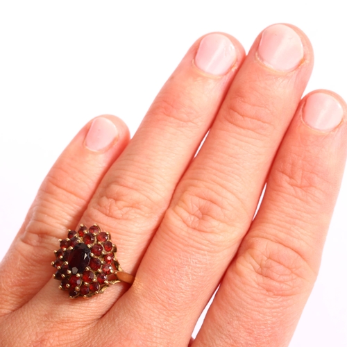 1197 - A late 20th century 9ct gold garnet oval cluster ring, set with oval mixed and round-cut garnets, se... 