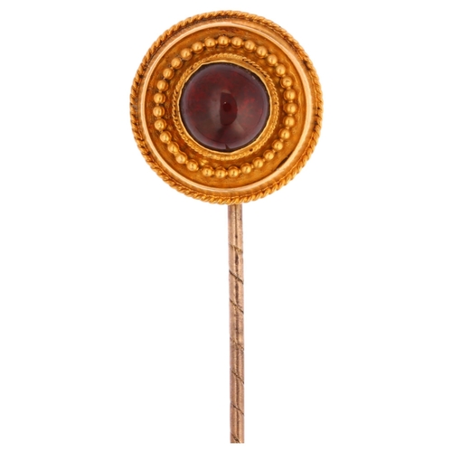 1206 - A Victorian Etruscan Revival garnet stickpin, unmarked gold settings with round cabochon garnet, hea... 