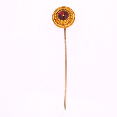 1206 - A Victorian Etruscan Revival garnet stickpin, unmarked gold settings with round cabochon garnet, hea... 