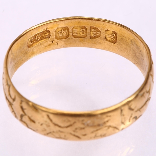 1227 - An early 20th century 18ct gold wedding band ring, maker JGG, Chester 1901, floral engraved decorati... 