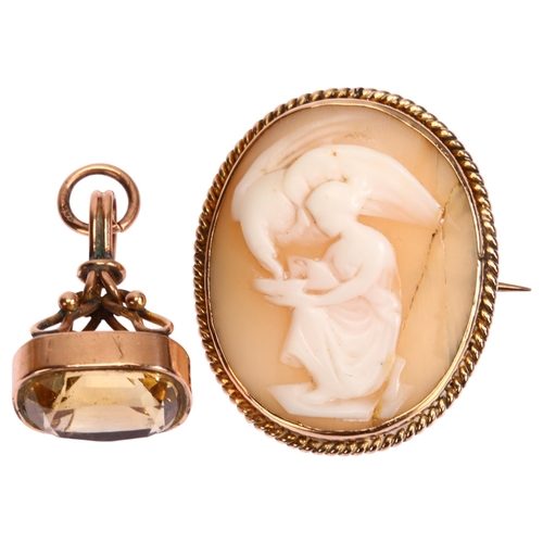 1275 - An Antique 9ct gold citrine fob, and an unmarked gold mounted shell cameo brooch, depicting Hebe fee... 