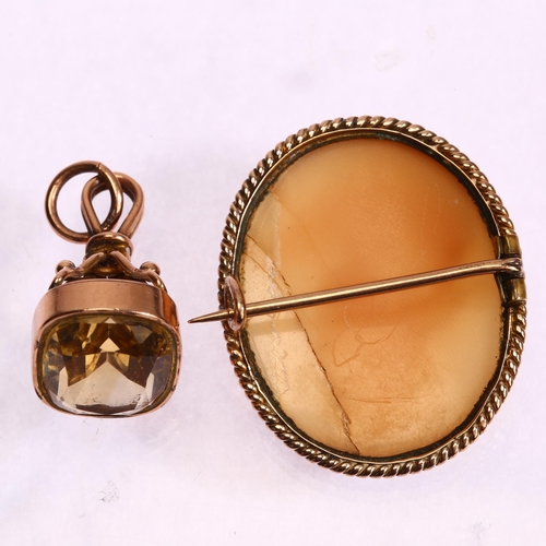 1275 - An Antique 9ct gold citrine fob, and an unmarked gold mounted shell cameo brooch, depicting Hebe fee... 