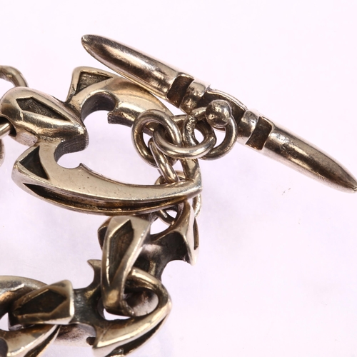 1293 - A sterling silver vertebrae link bracelet, with bow and arrowhead interlocking clasp, length 23.5cm,... 