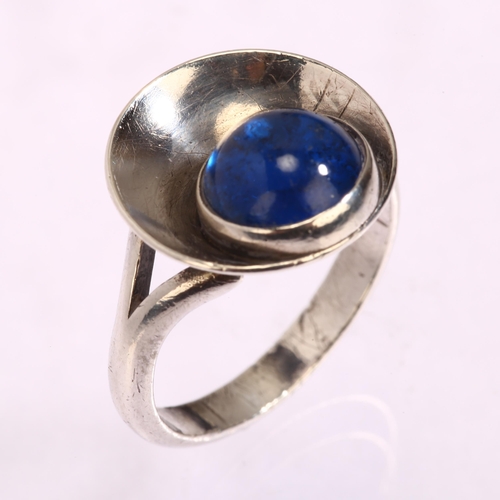 1296 - N E FROM - a Danish sterling silver ring, with cabochon blue glass panel, setting width 15mm, size N