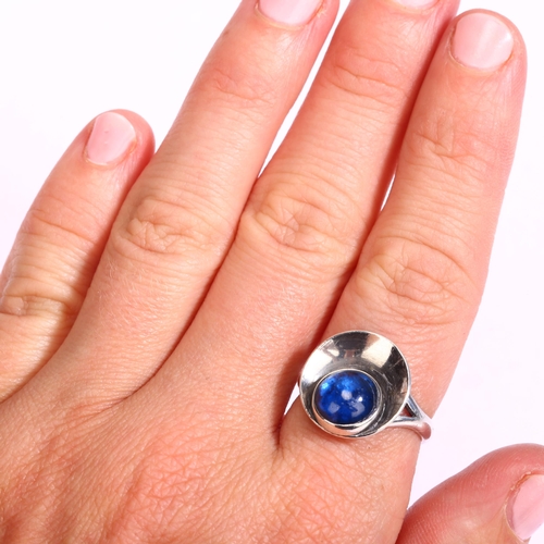 1296 - N E FROM - a Danish sterling silver ring, with cabochon blue glass panel, setting width 15mm, size N