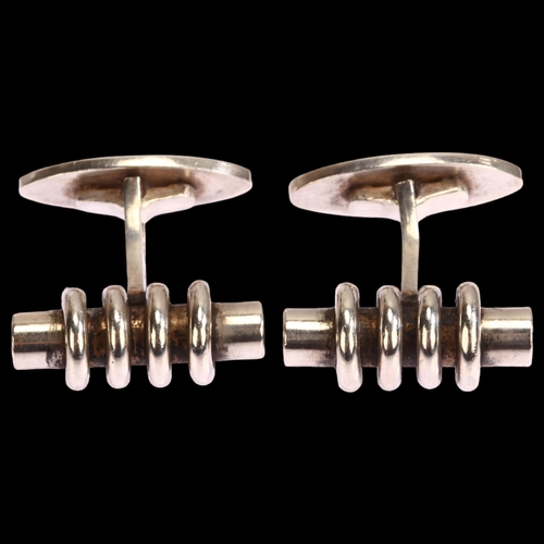 1297 - A pair of Danish sterling silver cufflinks, possibly Gunnar Andresen, of ringed cylindrical form, le... 