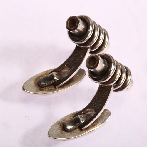 1297 - A pair of Danish sterling silver cufflinks, possibly Gunnar Andresen, of ringed cylindrical form, le... 