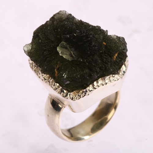 1299 - A moldavite natural green glass and silver ring, setting height 25mm, size N, 16.6g.  Moldavite is a... 