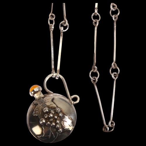 1305 - A silver and amber set flask design pendant necklace, with applied grape and vine decoration, on lon... 