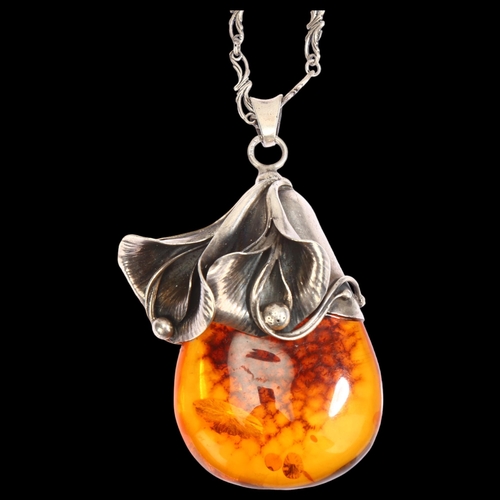 1307 - A large amber and silver flower drop design pendant and chain, pendant length excluding bale 58mm, 5... 