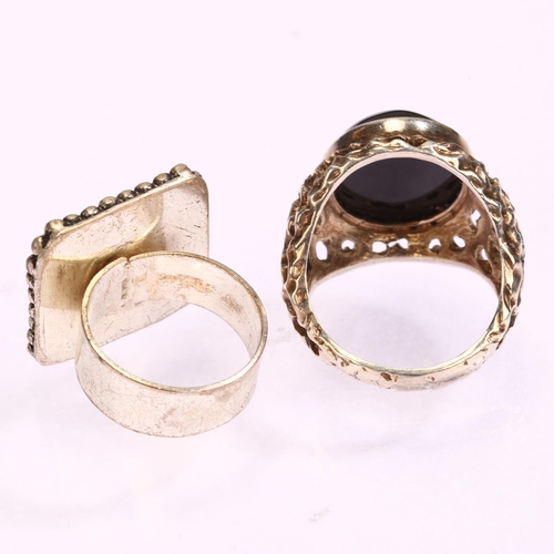 1311 - A large cast silver black onyx signet ring, setting width 25mm, size S, 11.3g, and an unmarked white... 