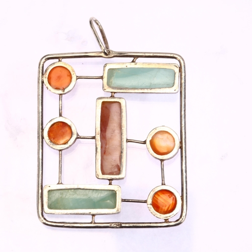 1312 - An unmarked silver agate and hardstone set abstract design pendant, 50 x 40mm