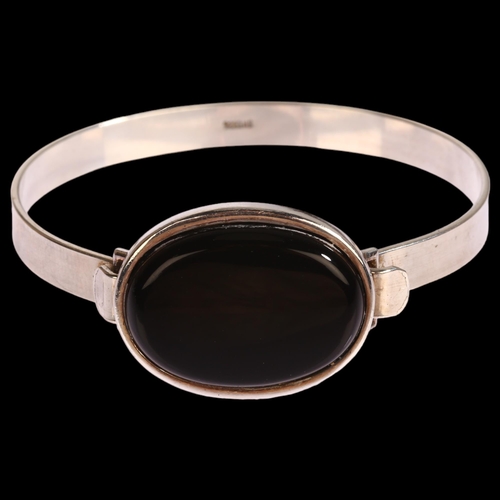 1336 - HERMANN SIERSBOL - a Danish modernist sterling silver and black onyx torque bangle, setting height 2... 