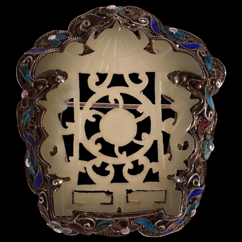 1340 - A Chinese carved and pierced jade brooch in silver filigree and enamel shaped setting, 50 x 45mm, 19... 