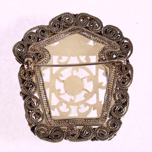 1340 - A Chinese carved and pierced jade brooch in silver filigree and enamel shaped setting, 50 x 45mm, 19... 