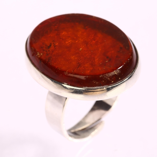 1344 - N E FROM - a Danish sterling silver ring with amber panel, setting height 30mm, 11.5g