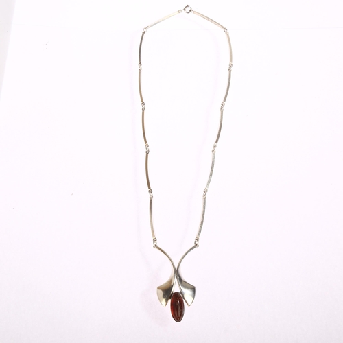 1346 - N E FROM - a Danish sterling silver pendant necklace, set with a central amber stone, length 49cm