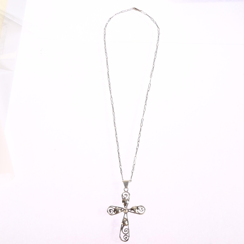 1362 - A silver leaf and scroll design cross pendant on silver chain, cross height excluding bale 55mm, 9g