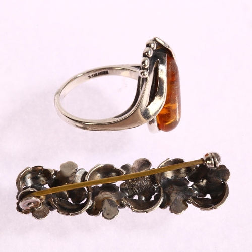 1377 - N E FROM - a Danish sterling silver and amber ring, and a sterling silver floral design brooch, leng... 