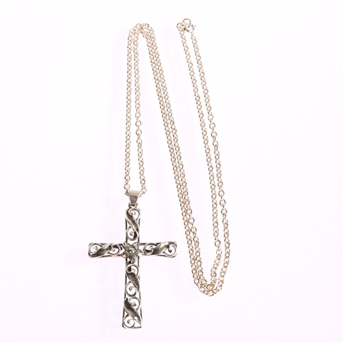 1380 - LARS BRAEMER-JENSEN - an ornate silver scroll design cross pendant on sterling silver chain, cross l... 