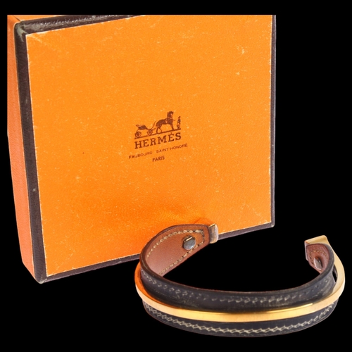 1381 - HERMES - a Vintage gold plate and leather bangle, 6.5cm across, 21.5g, original box