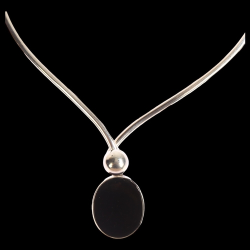 1389 - N E FROM - a Danish sterling silver and onyx neck torque, with sprung fastener, onyx length 30mm, 56... 