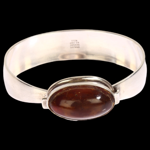 1391 - N E FROM - a Danish sterling silver bracelet, with central oval amber panel, amber length 25mm, inte... 