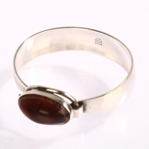 1391 - N E FROM - a Danish sterling silver bracelet, with central oval amber panel, amber length 25mm, inte... 