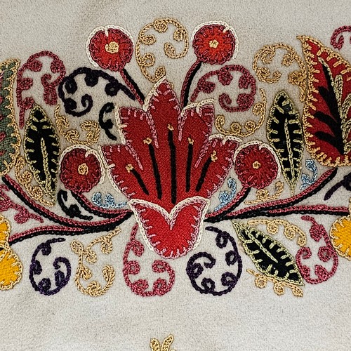 118 - 2 early 20th century crewel embroidered panels, 58cm across, 1 with a rope border, the other mounted... 