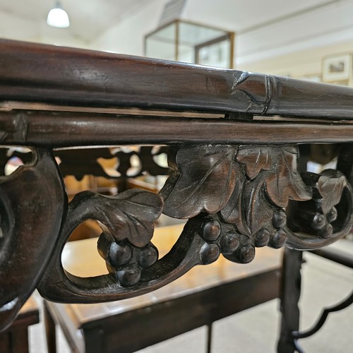 199 - A Chinese 19th century rosewood altar table, with grapevine carved and pierced frieze on carved supp... 