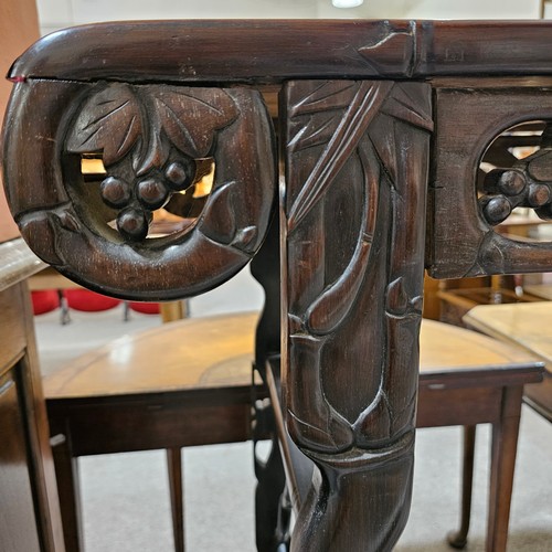 199 - A Chinese 19th century rosewood altar table, with grapevine carved and pierced frieze on carved supp... 