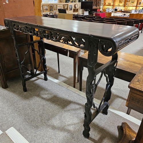 199 - A Chinese 19th century rosewood altar table, with grapevine carved and pierced frieze on carved supp... 