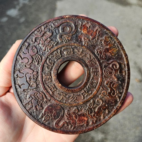 150 - A Chinese relief cast-bronze mirror, diameter 17.5cm, and a Chinese relief carved stone bi-disc, dia... 