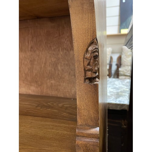 76 - Gnomeman floor standing golden oak open bookcase, with relief carved frieze and shaped ends, width 9... 