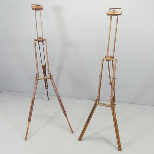 2719 - A pair of antique teak folding artists easels, both impressed 