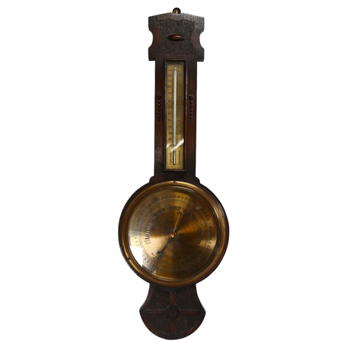 104 - An Art Nouveau oak-framed aneroid barometer with thermometer, by Kendal & Dent, L77cm