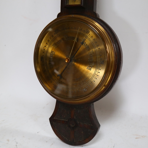 104 - An Art Nouveau oak-framed aneroid barometer with thermometer, by Kendal & Dent, L77cm