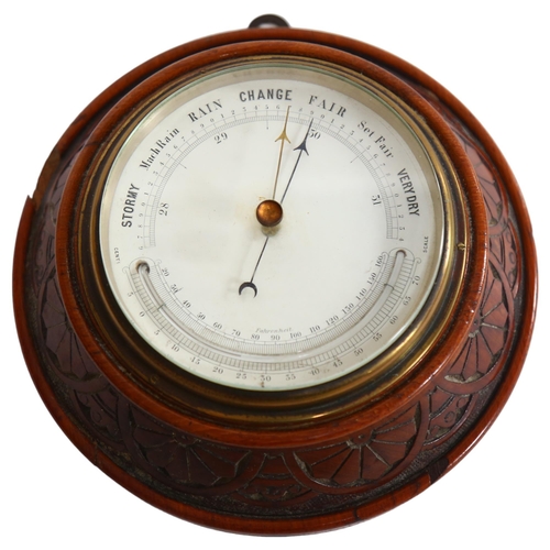 105 - An Edwardian carved oak-cased combination aneroid barometer with thermometer, diameter 20cm