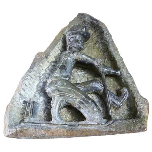 11 - A hand carved green serpentine sculpture, depicting a miner, H46cm (AF)