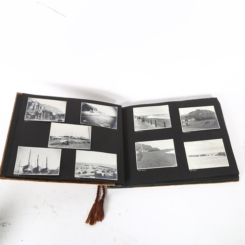 124 - An album of black and white photographs, depicting Hastings scenes, including fishing boats and harb... 