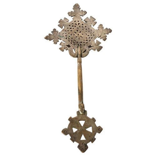 127 - An Ethiopian Coptic cross with pierced and engraved decoration, L28cm