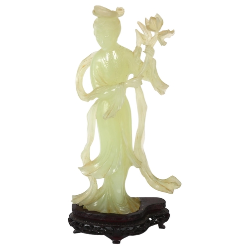 149 - A jadeite figure of a Chinese lady holding flowers on stand, H26cm