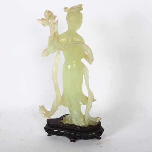 149 - A jadeite figure of a Chinese lady holding flowers on stand, H26cm