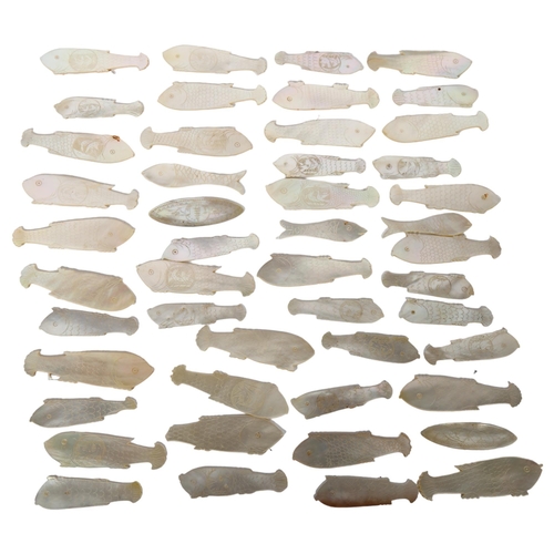 150 - A collection of Chinese carved mother-of-pearl fish design gaming counters