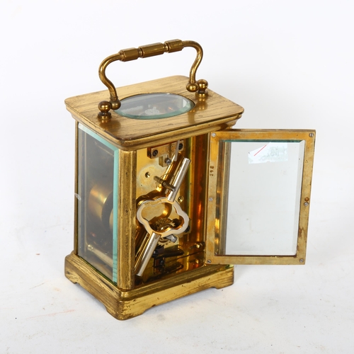 153 - A brass-cased carriage clock, enamel dial and Roman numerals, case height not including handle 10.5c... 