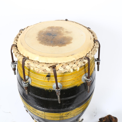 21 - A barrel -shaped bongo drum, and carved wood club, drum height 44cm