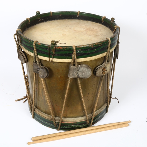 22 - A 20th century military drum, with brass body and painted wood mounts, H38cm, D37cm, and a pair of d... 