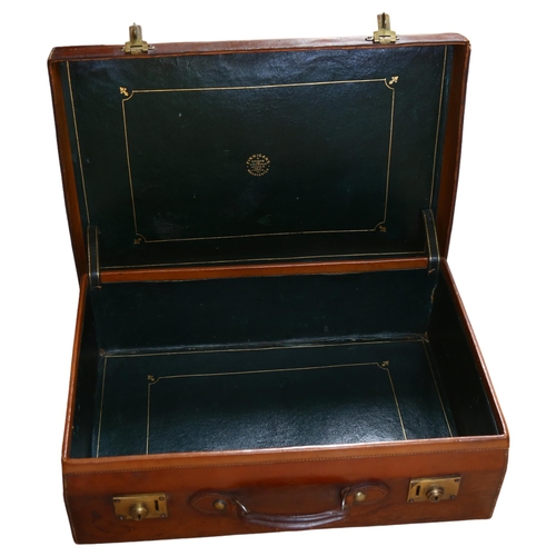 78 - FINNIGANS - a Victorian leather suitcase, tooled green leather interior, brass plate locks both impr... 