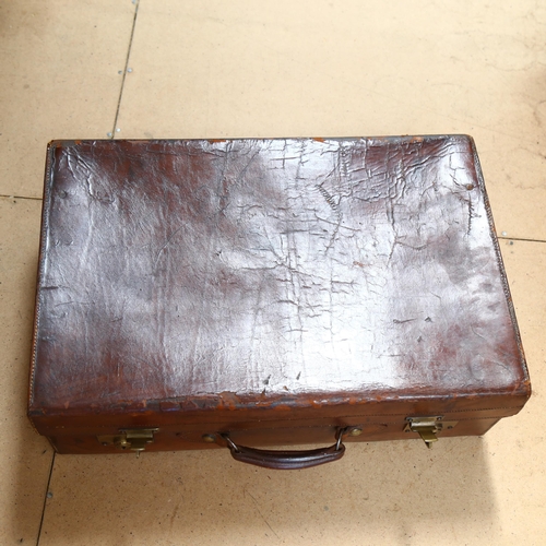 78 - FINNIGANS - a Victorian leather suitcase, tooled green leather interior, brass plate locks both impr... 