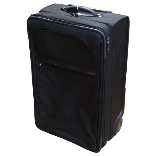 79 - A Tumi wheeled suitcase, with label to the inside, no. 22022D4, H58cm not including handle